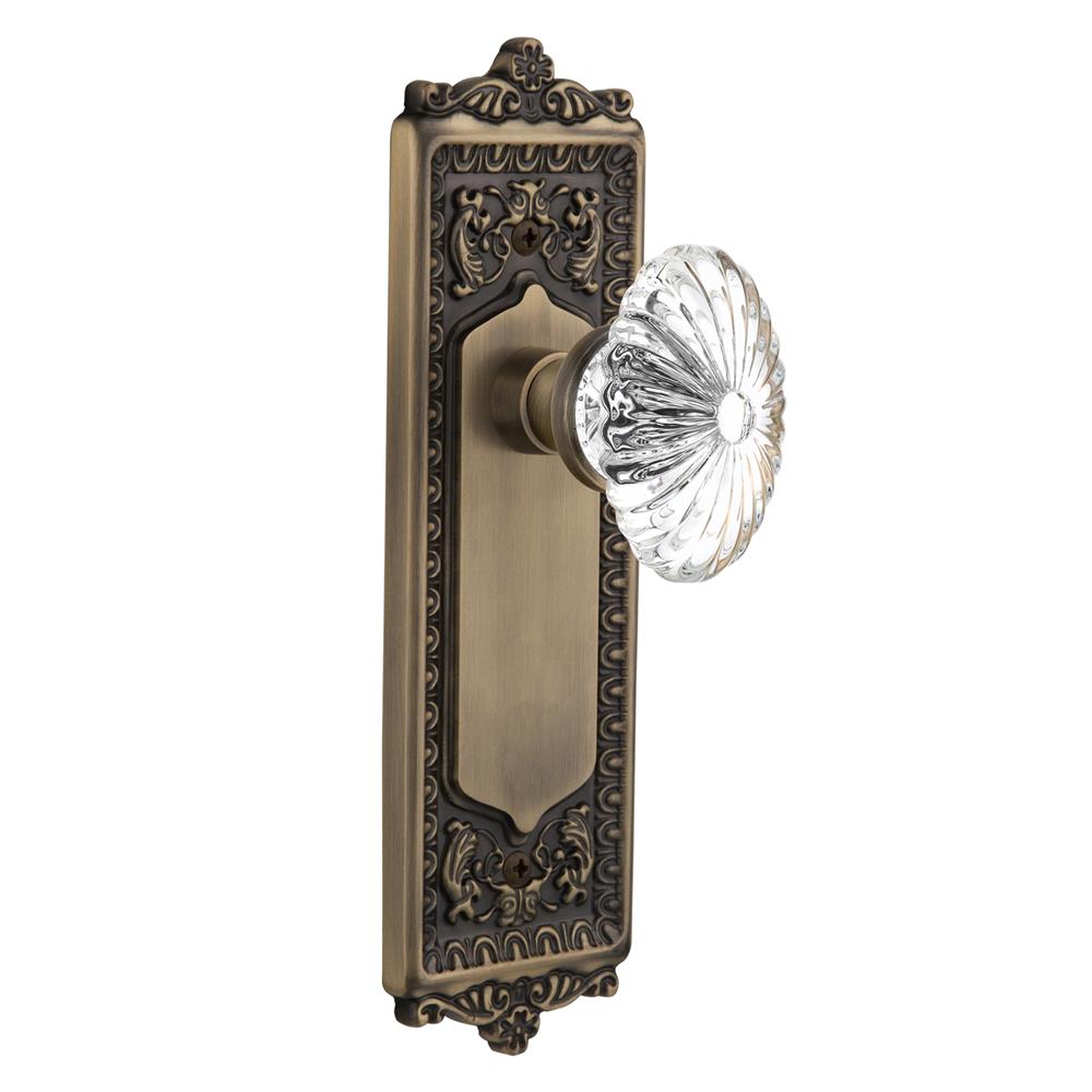 Nostalgic Warehouse EADOFC Passage Knob Egg and Dart Plate with Oval Fluted Crystal Knob without Keyhole in Antique Brass